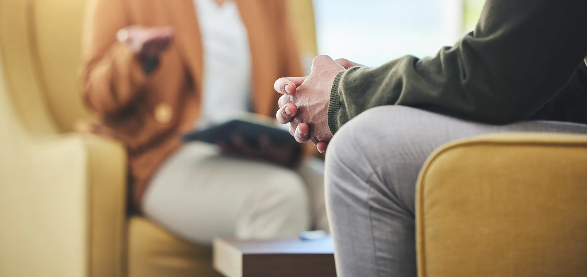 A man sitting with folded hands