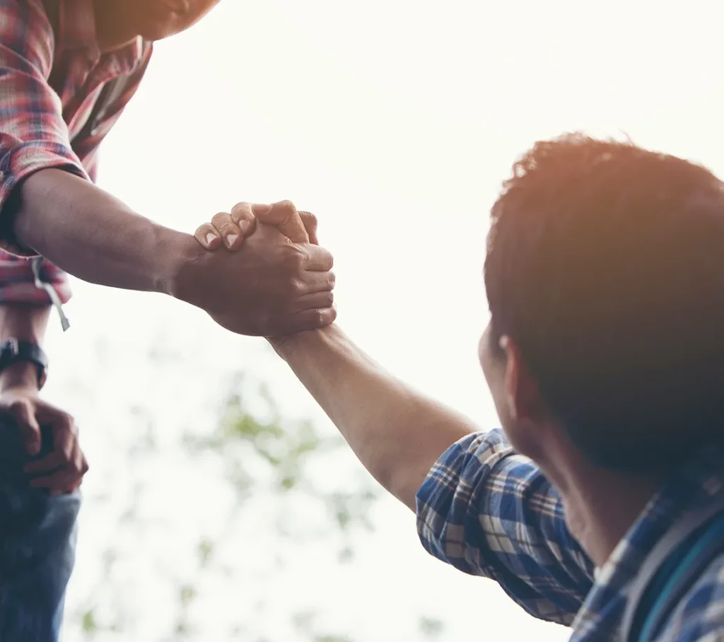 One man helping another man up